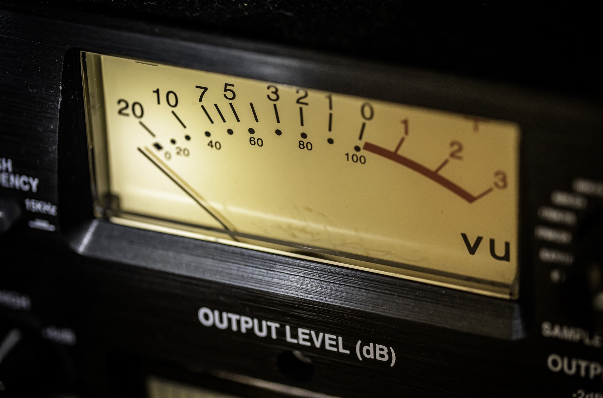 Audio level meter lights on a professional mixing console during studio session